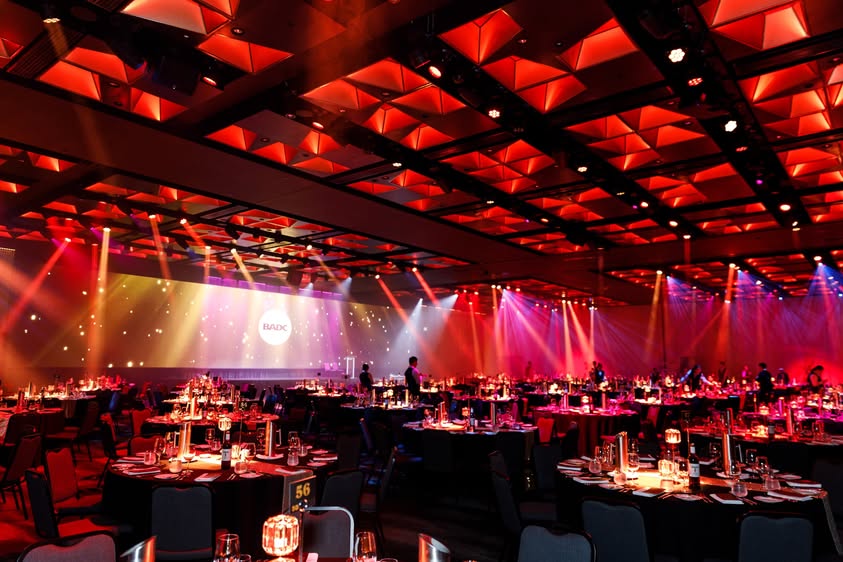 BADC Awards pre-show — red ambient lighting across ballroom